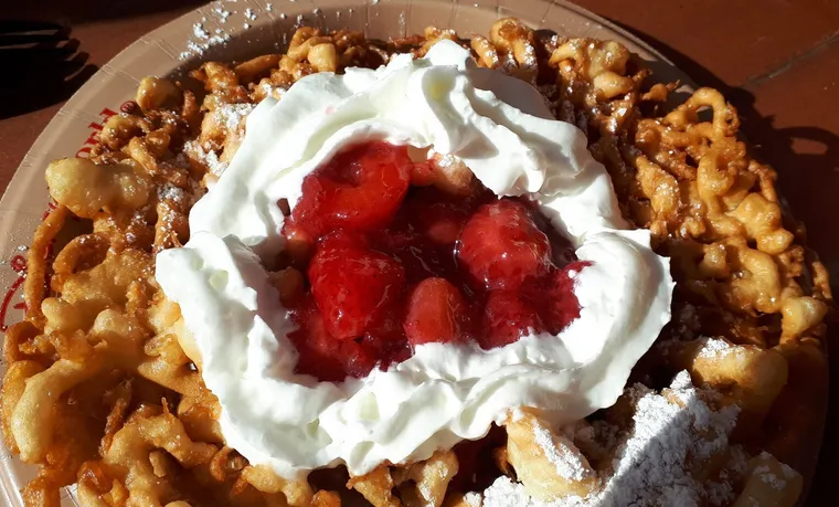 Funnel cake with cream and strawberries