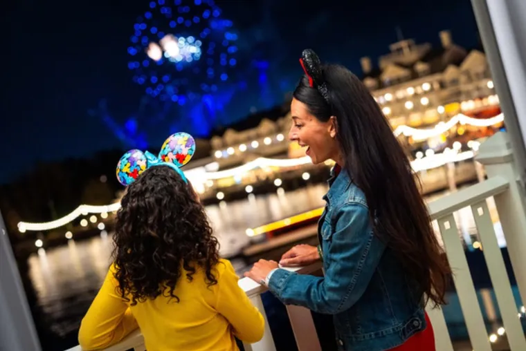 A VIEW OF FIREWORKS ACROSS CRESCENT LAKE OVER THE BOARDWALK